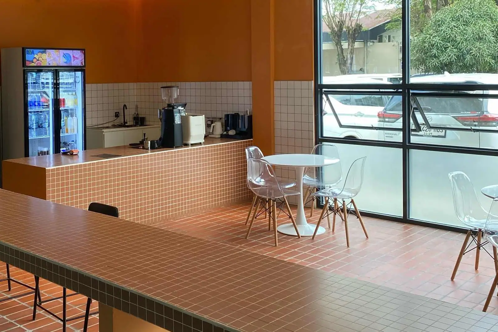Café with terracotta tiled bar and white chairs
