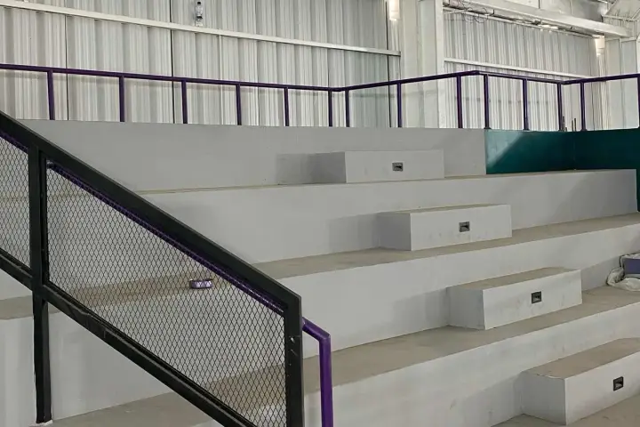 Concrete tribune steps with violet railings